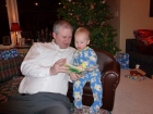 Kenyon reading with his grandpa on the brand new mini sofa that his parents gave him for Christmas.