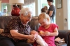 Grandma Pat and Emmy feeding the doll