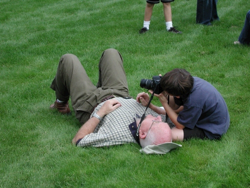 Clark's not trying to choke Grandpa -- he just wants to take a look through his camera!