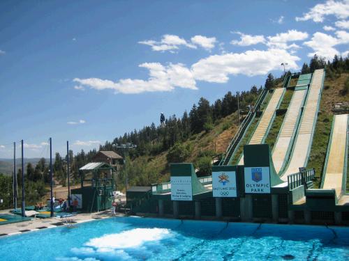 then twist and turn, and then land in the water.  If you look closely you can see a black figure just above the trees that has jumped off the 1st platform on the left and is about to do his twists and turns.  They turn on bubbles in the water to cushion their fall.  It was fascinating -- more fun to watch on video and of course in real life.