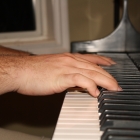 Playing our newly-tuned piano! We had it tuned that day to surprise him!