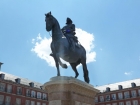 There is a bronze statue of King Philip III at the center of the square, created in 1616.