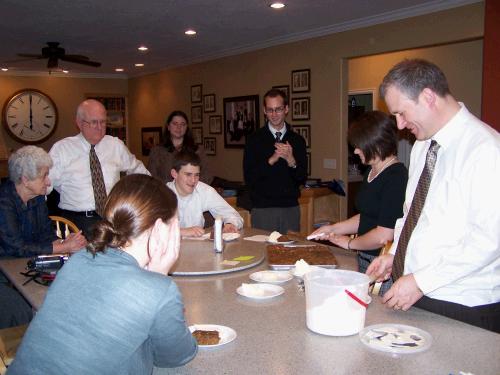 Everyone gathered around to have a piece of the cake.