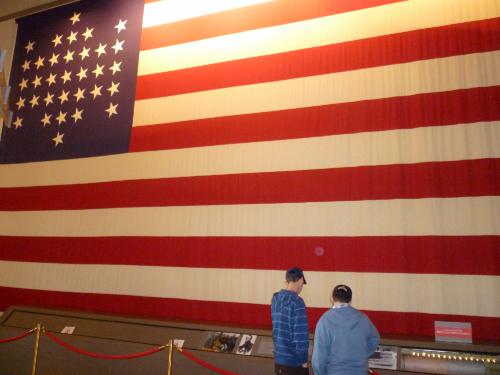 This is an actual size replica of the flag that was flown over Fort Sumter.  The real one is falling apart, but is rolled up and preserved in the long box below that has a window where you can see a piece of it.  Elliot and Clark are checking it out.