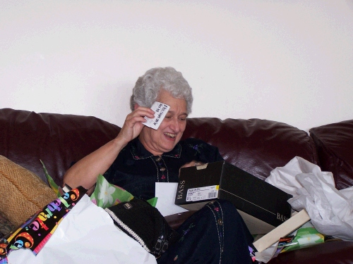 Pat enjoying a small note from Clark wrapped several times in consecutively bigger boxes and bags!