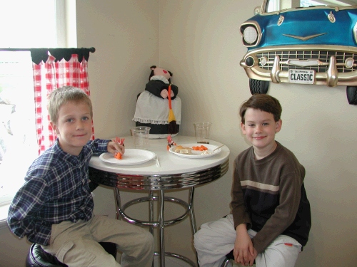 Clark with his cousin Parker Morgan. 
All the little kids had their Thanksgiving dinner downstairs together...and then they all watched a movie while we had dinner upstairs - theoretically the babies were all napping on yet another floor.  You have to get creative when you have 30 people - mostly kids!