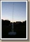 It probably went 200 feet into the air.  He launched it three times, but on the third time it drifted in the wind onto a neighbor's roof and so we were done for the day. Very fun -- the kids loved it!